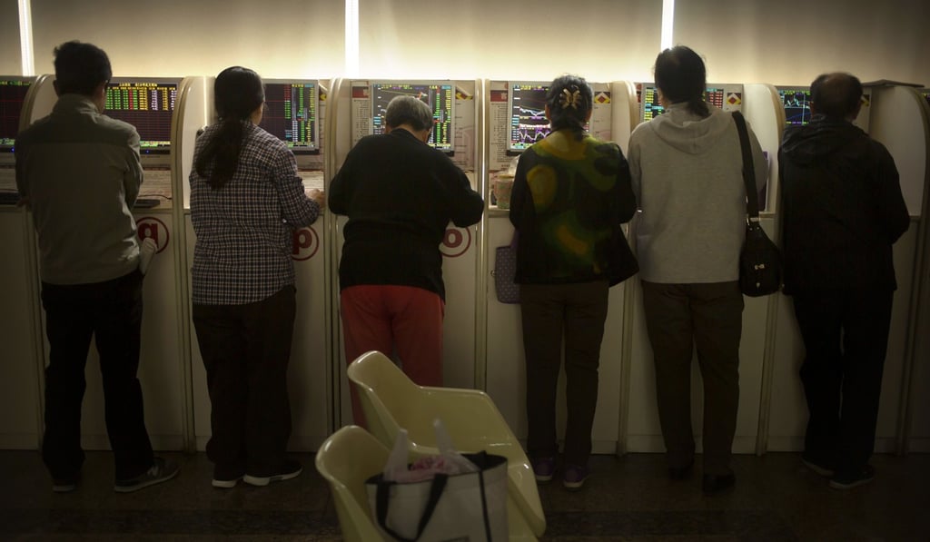 Chinese investors use computer terminals to monitor stock prices at a brokerage house in Beijing on April 19, 2019. Photo: AP