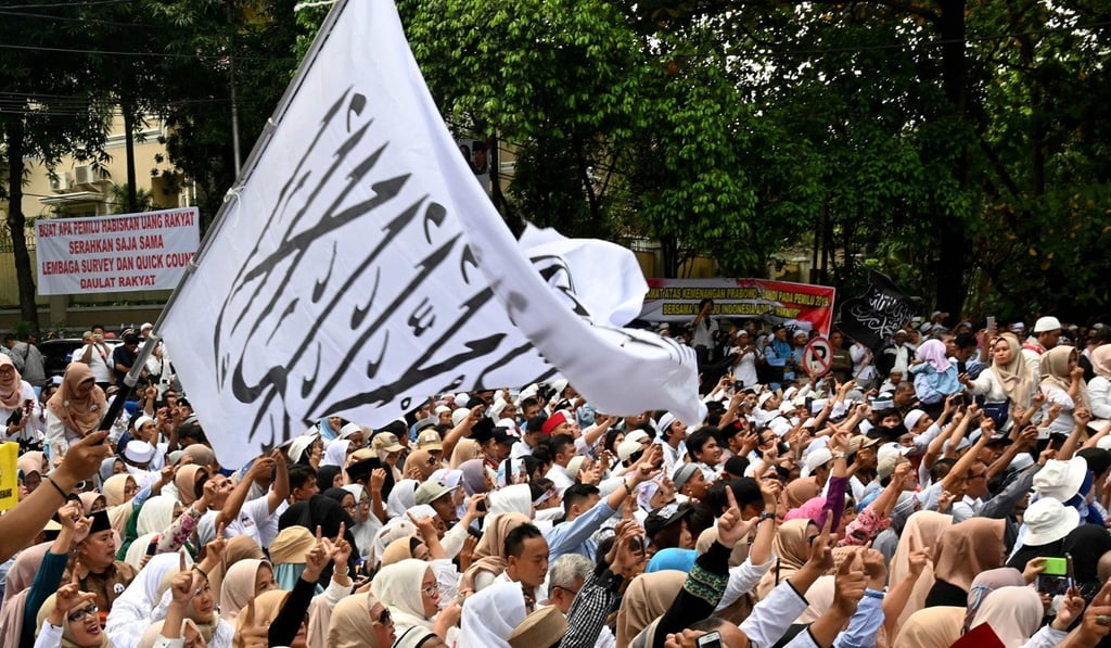 Supporters reacts as Prabowo delivers a speech outside his home on Friday. Photo: AFP