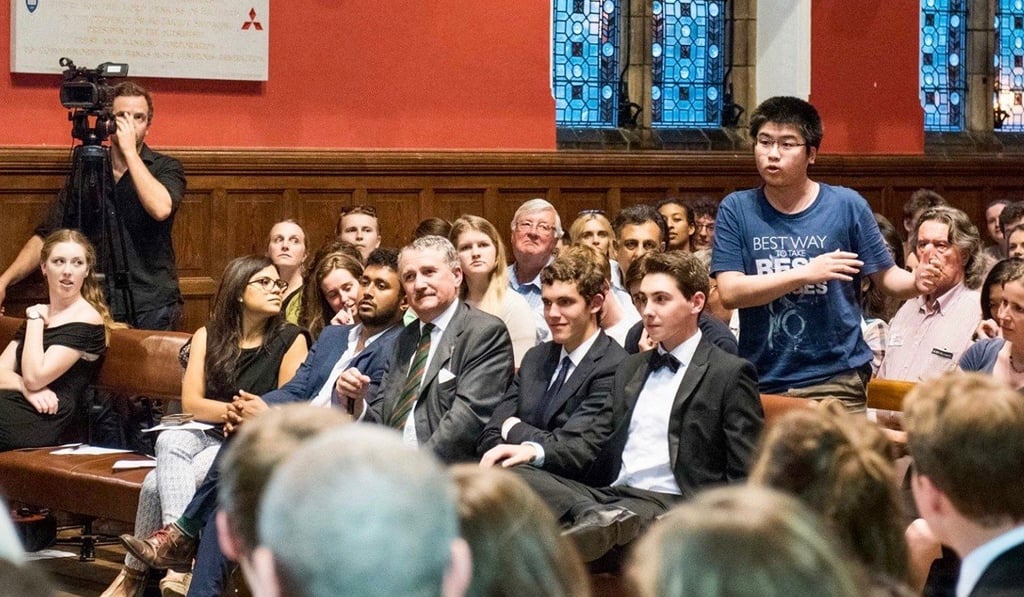 Brian Wong (standing) participates in an Oxford Union discussion at Oxford University, the UK.