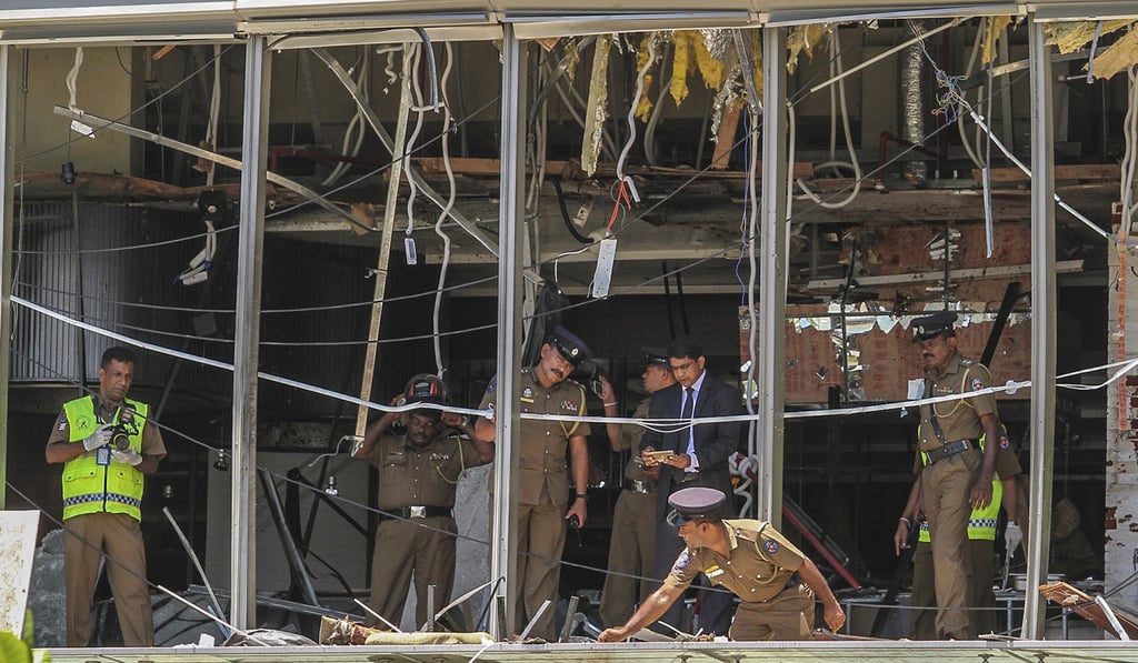 A Sri Lankan Police officer inspects a blast spot at the Shangri-la hotel in Colombo. Photo: AP