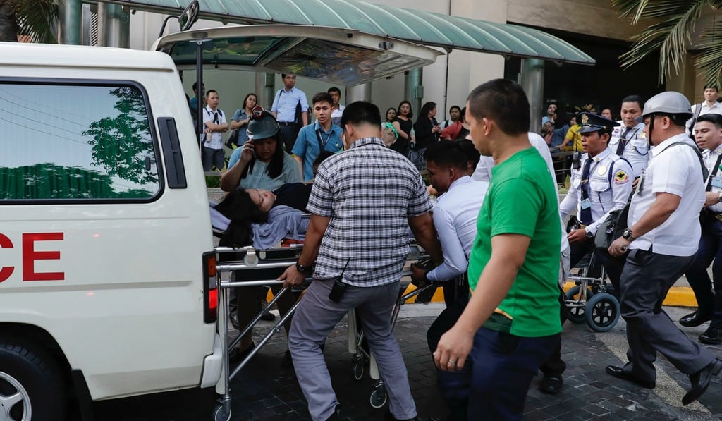 Philippine rescuers carry a woman to an ambulance after an earthquake struck the island of Luzon. Photo: AP Philippine rescuers carry a woman to an ambulance after an earthquake struck the island of Luzon. Photo: AP