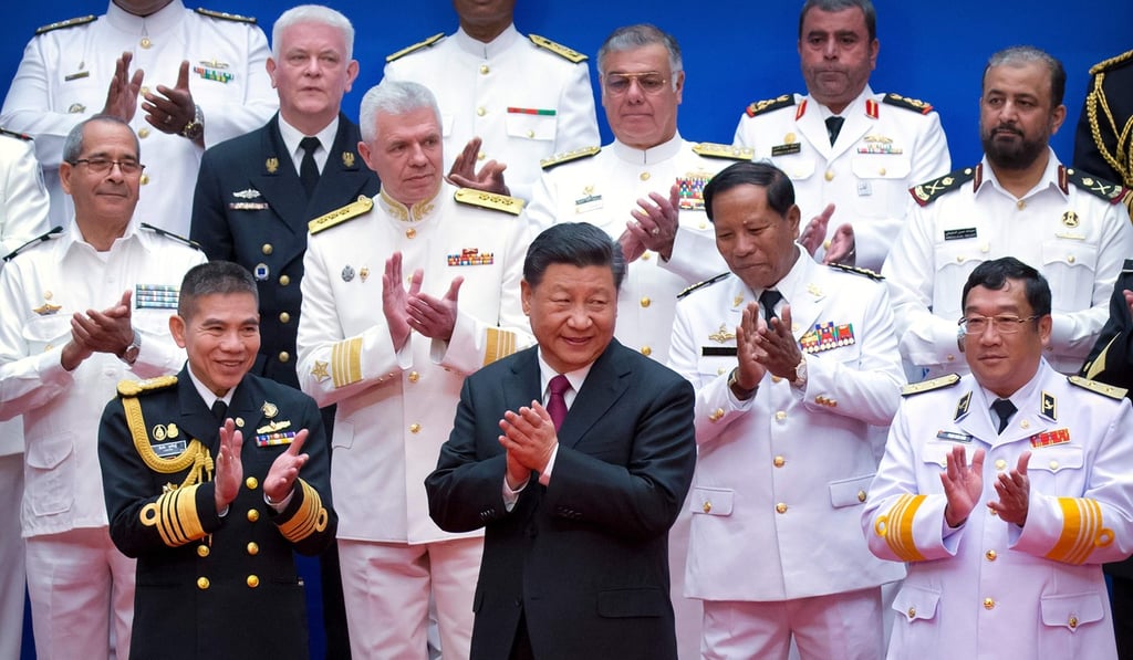 Chinese President Xi Jinping surrounded by Chinese and foreign naval commanders at the event. Photo: AFP Chinese President Xi Jinping surrounded by Chinese and foreign naval commanders at the event. Photo: AFP