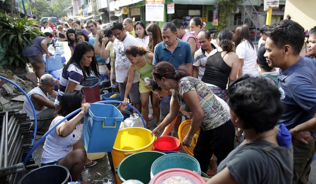 Filipinos fill up empty buckets during a water distribution exercise east of Manila in February. The government has advised the public to conserve water during droughts. Photo: EPA