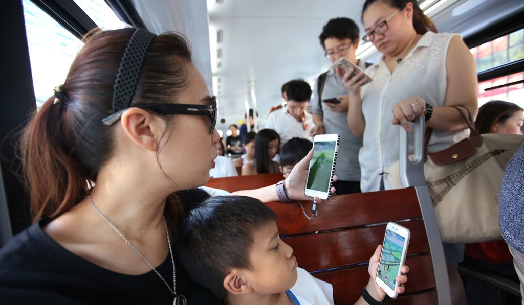Commuters playing Pokemon Go on the tram in Hong Kong in August 2016. Photo: Edward Wong