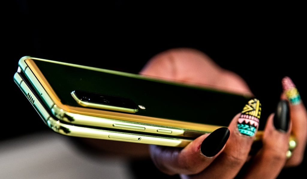 An attendee holds a Samsung Galaxy Fold at an unveiling event in New York on April 15. Photo: Jeenah Moon/Bloomberg