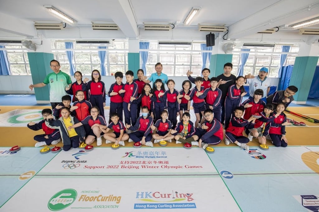 John Li, students and teachers from the Canton Road Government Primary School show their support for the 2022 Beijing Winter Olympics.