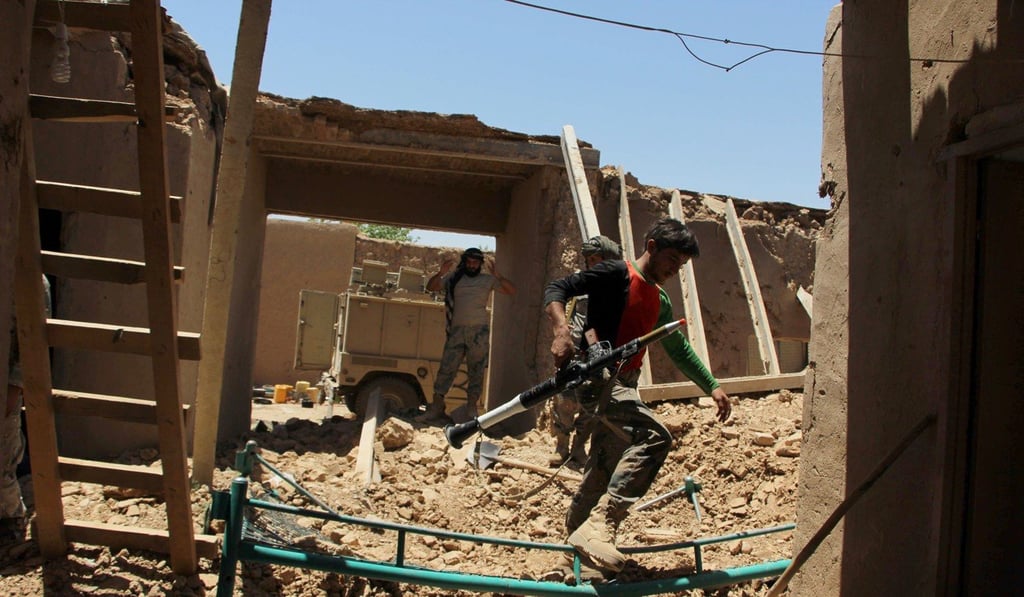 Afghan Border Police inspect an outpost damaged in an air strike in the Nad Ali district of Helmand province. File photo: AFP