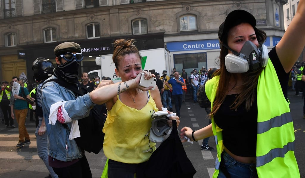 A woman reacts during clashes between protesters and anti-riot police in Paris on Saturday, as thousands of ‘yellow vest’ demonstrators took to the streets. Photo: AFP