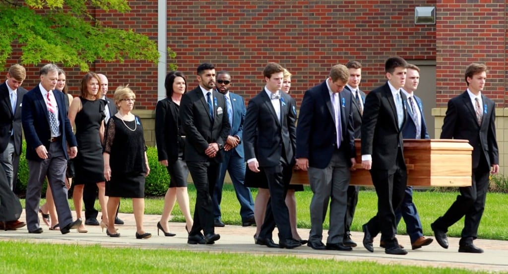 Fred and Cindy Warmbier follow the casket of their son, Otto Warmbier, to the hearse after his funeral in June 2017. Photo: Reuters