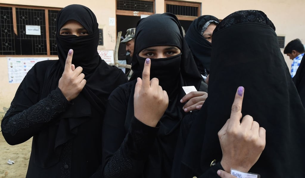 Muslim women show their fingers after voting in Muzaffarnagar, Uttar Pradesh in February 2017. Photo: AFP