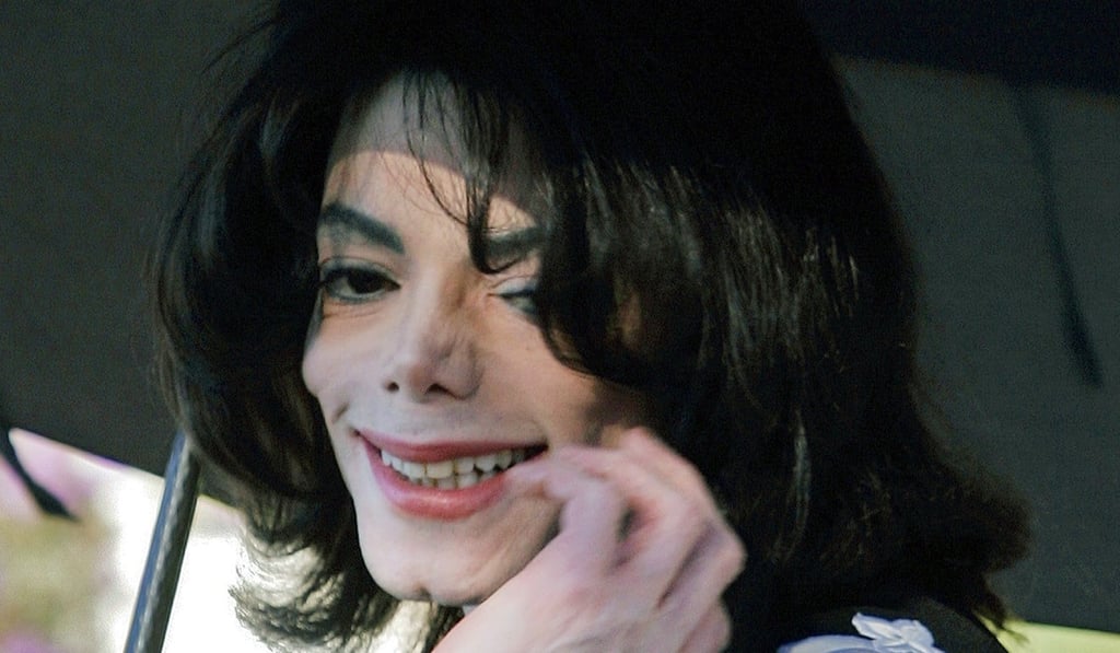 Pop star Michael Jackson gestures after greeting several hundred children who were invited guests at his Neverland Ranch home. File Photo: AP Photo