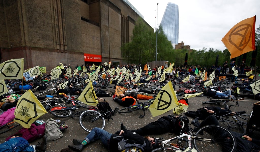 Cyclists lie down as they take part in the Extinction Rebellion protest at the Tate Modern in London. Photo: Reuters