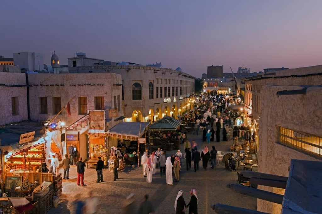 The restored Souk Waqif bazaar with its mud-rendered shops and exposed timber beams. Photo: Alamy