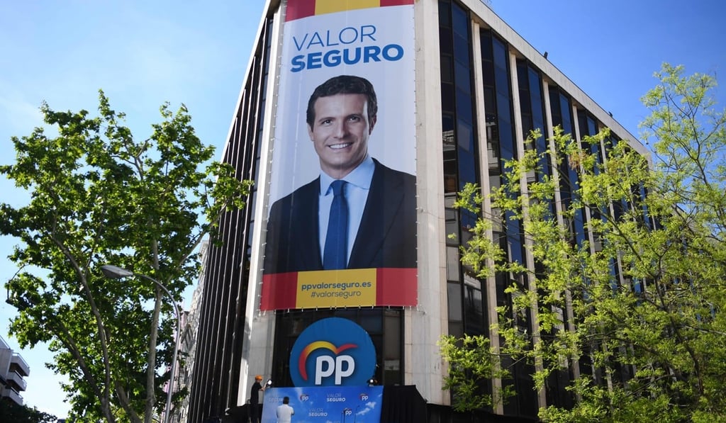 A poster of Spanish conservative People’s Party (PP) leader and candidate for prime minister Pablo Casado hangs from the PP headquarters. Photo: AFP