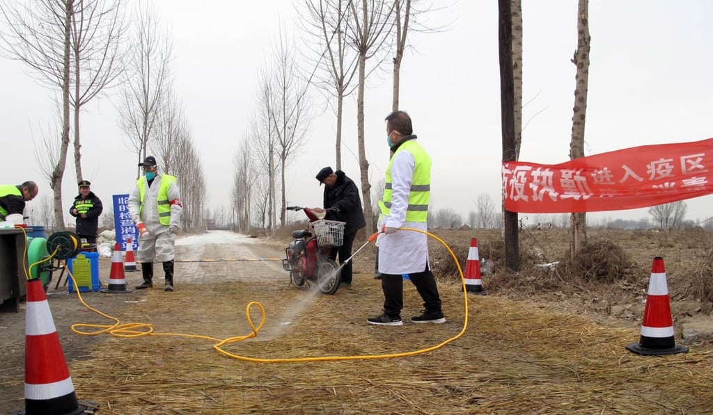 Police officers and workers in protective suits are seen at a checkpoint on a road leading to a farm where African Swine Fever was detected, in China’s northern Hebei province, in this file photo from February this year. Photo: Reuters
