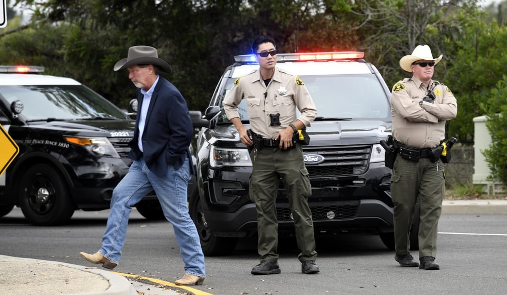 Poway Mayor Steve Vaus, left, walks away after talking to San Diego county sheriff's deputies outside of the Chabad of Poway synagogue. Photo: AP photo