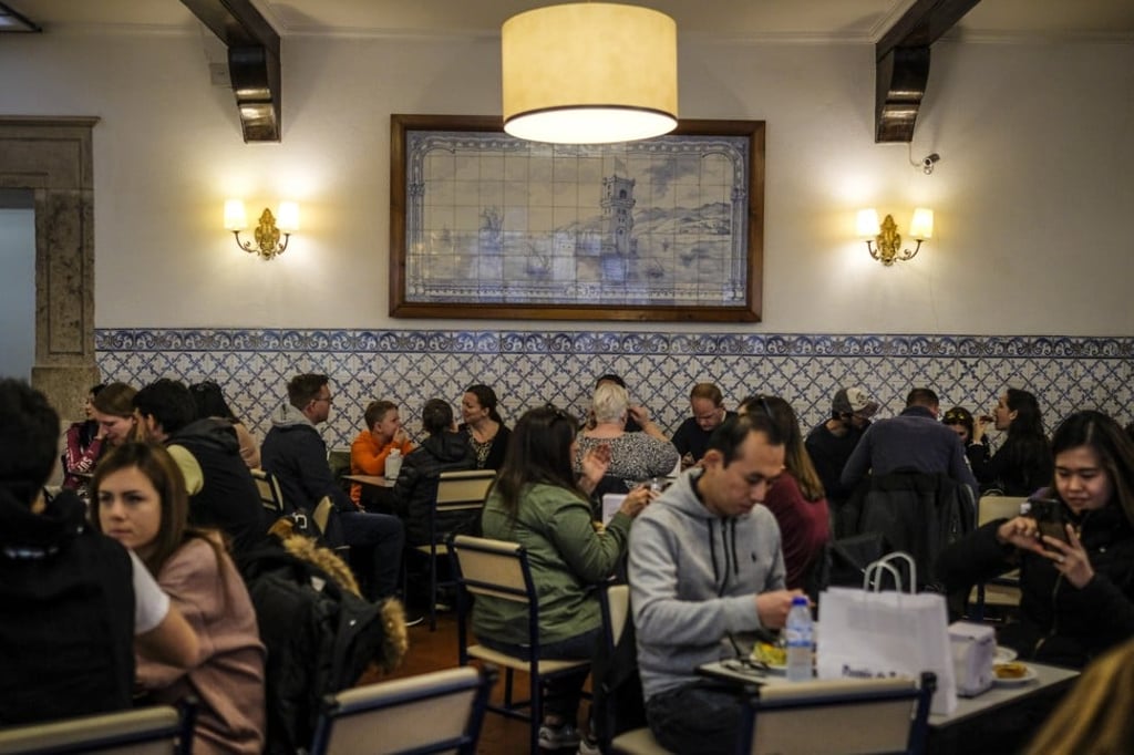Customers eat at Pasteis de Belem cafe. Photo: Bloomberg Customers eat at Pasteis de Belem cafe. Photo: Bloomberg