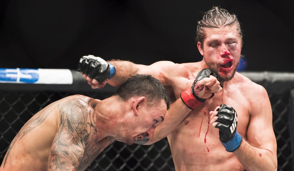 Max Holloway (left) and Brian Ortega throw punches during their featherweight championship mixed martial arts bout at UFC 231 in Toronto last December. Photo: AP