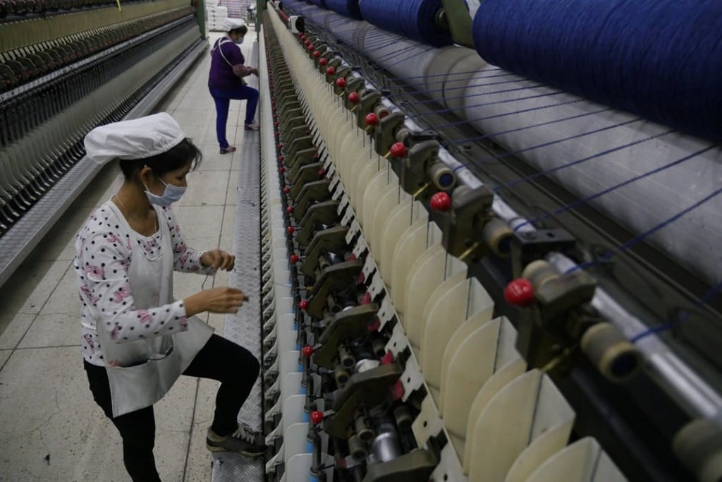 A worker disentangles wool yarn at a spinning machine at a factory owned by Hong Kong's Novetex Textiles Limited in Zhuhai City, Guangdong Province. Photo: Reuters