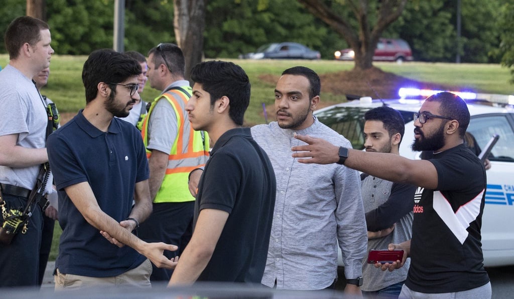 People gather across from the campus of University of North Carolina at Charlotte after a shooting at the school. Photo: AP