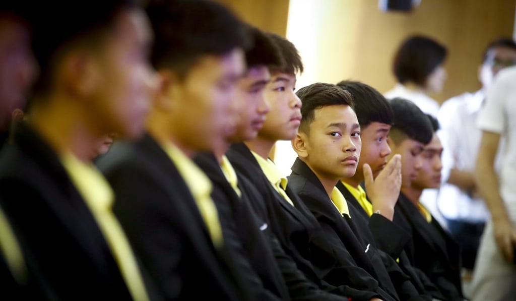 Members of the soccer team at a news conference to announce the deal. Photo: EPA