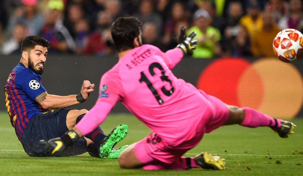 Luis Suarez scores past Liverpool goalkeeper Alisson Becker. Photo: AFP Luis Suarez scores past Liverpool goalkeeper Alisson Becker. Photo: AFP