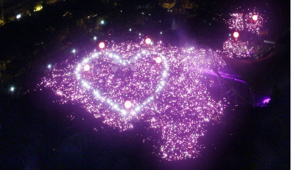 Attendees at Singapore’s Pink Dot event send their message in lights. Photo: EPA