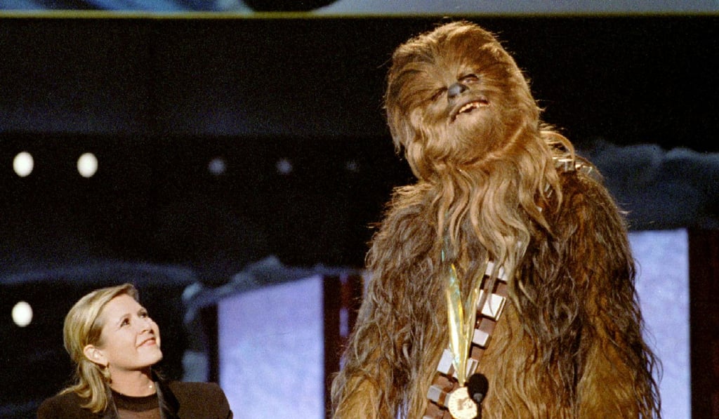 Chewbacca gives an acceptance speech in the Wookie own tongue upon receiving the MTV Movie Awards Lifetime Achievement prize from Carrie Fisher (left) in June 1997. Photo: Reuters
