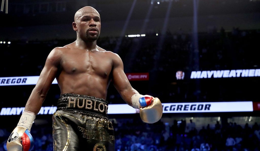 Floyd Mayweather Jnr walks to his corner while taking on Conor McGregor in Las Vegas, Nevada. Photo: AFP