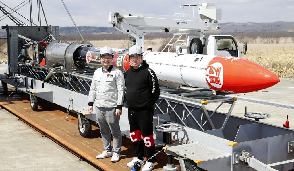 Interstellar Technologies Inc. President Takahiro Inagawa (left) and Takafumi Horie, who founded the aerospace venture, stand in front of its MOMO-3 rocket in Taiki, Hokkaido on April 12. Photo: Kyodo Interstellar Technologies Inc. President Takahiro Inagawa (left) and Takafumi Horie, who founded the aerospace venture, stand in front of its MOMO-3 rocket in Taiki, Hokkaido on April 12. Photo: Kyodo