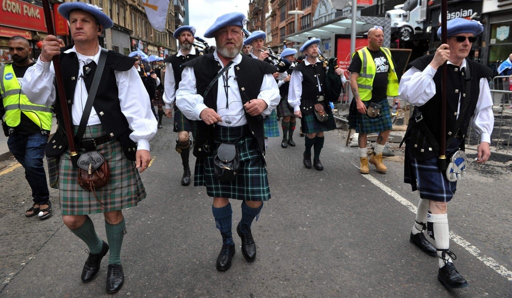 Pro-Scottish Independence activists wearing kilts and bonnets march through Glasgow. Photo: AFP