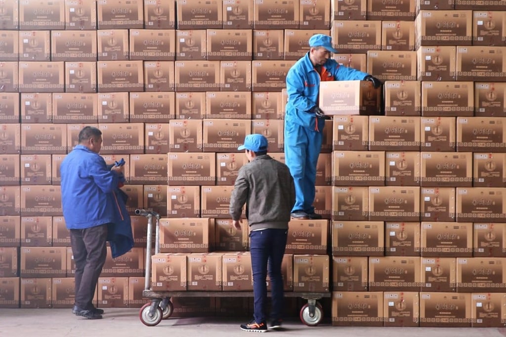 Workers transport boxes of baijiu at a Henan Yangshao Liquor plant in Sanmenxia, Henan province. Photo: Reuters