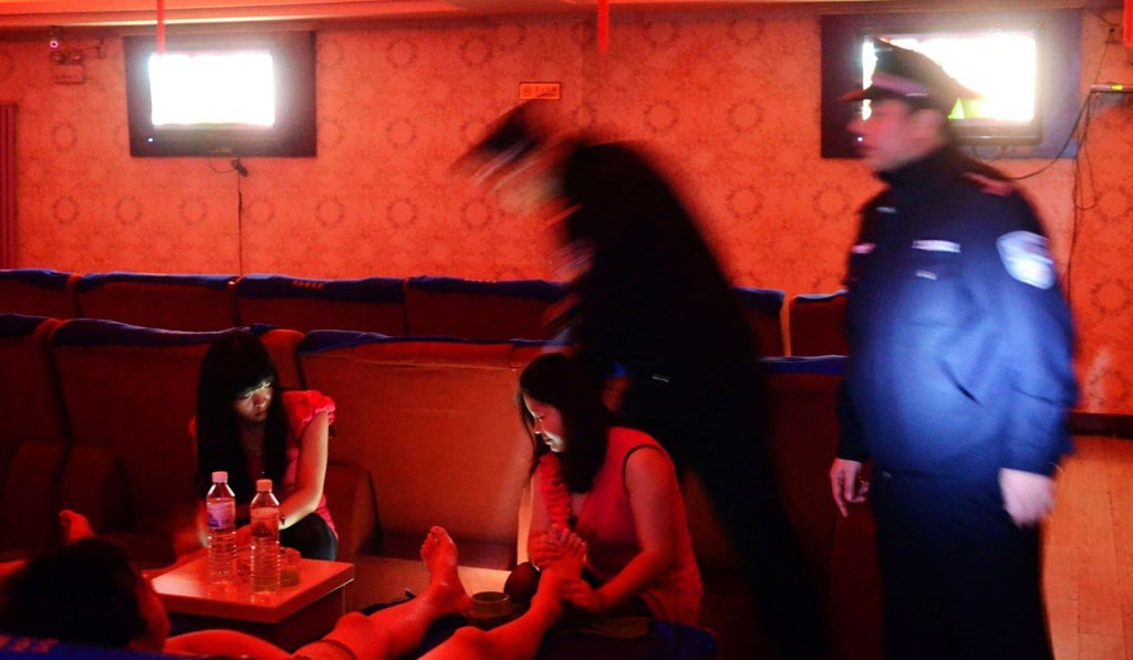 Police officers checking a public bath house in China's Shandong province in February 2014 amid a nationwide crackdown on the sex trade. Photo: AFP