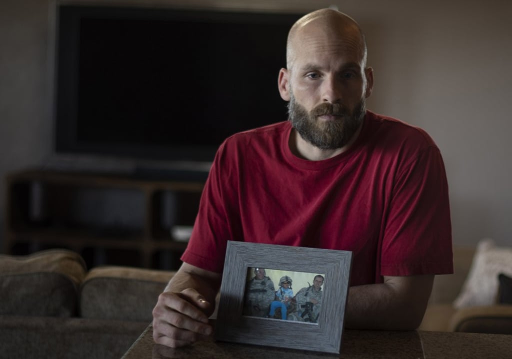 Behenna with a photo of two comrades who were killed by a roadside bomb in Iraq in 2008. Photo: The Washington Post Behenna with a photo of two comrades who were killed by a roadside bomb in Iraq in 2008. Photo: The Washington Post