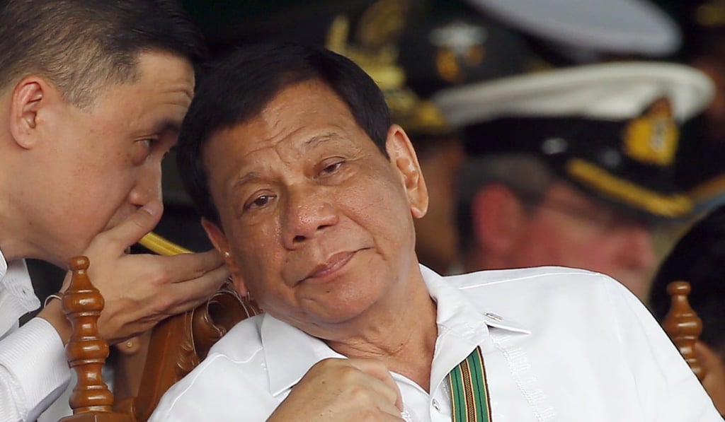 Duterte (right) with former presidential aide Christopher Go, who is also accused in the videos. Photo: AP