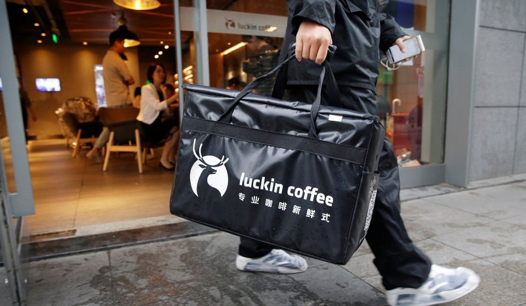 A delivery person leaves a Luckin Coffee store with a takeaway box for online sales in Beijing, China last year. Photo: Reuters