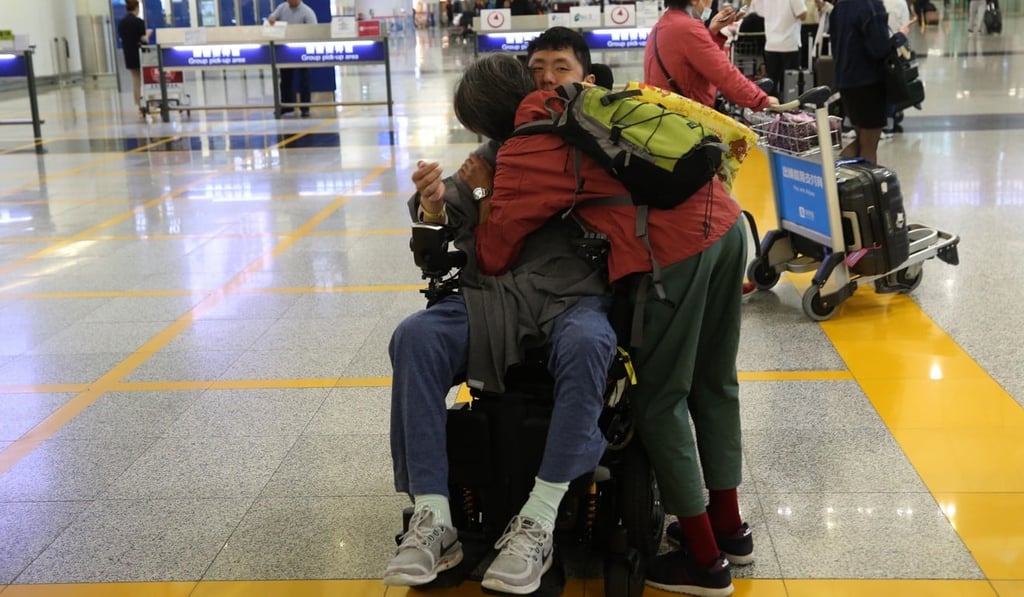 Jesher Yau is greeted by his mother at Hong Kong International Airport. Photo: Handout