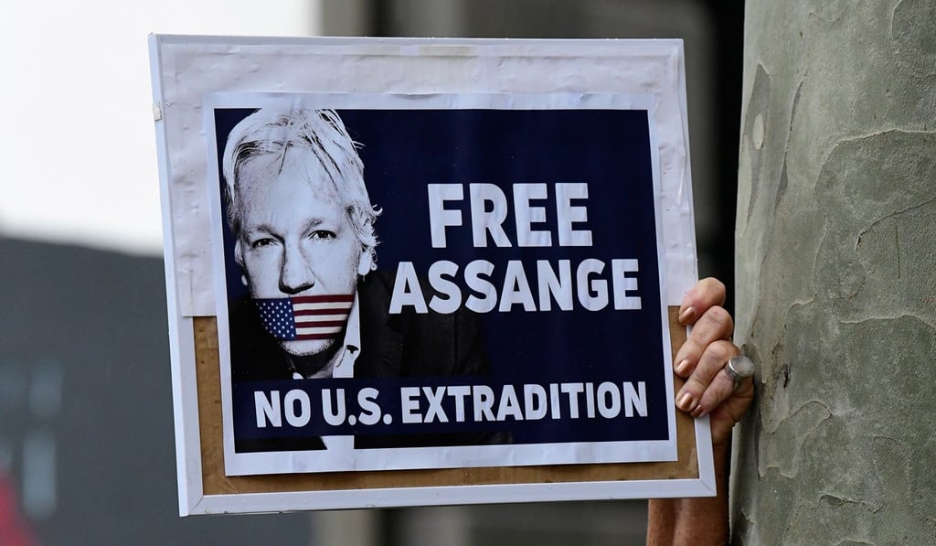 Protesters with placards gather during a rally in Sydney on Friday. Photo: EPA-EFE