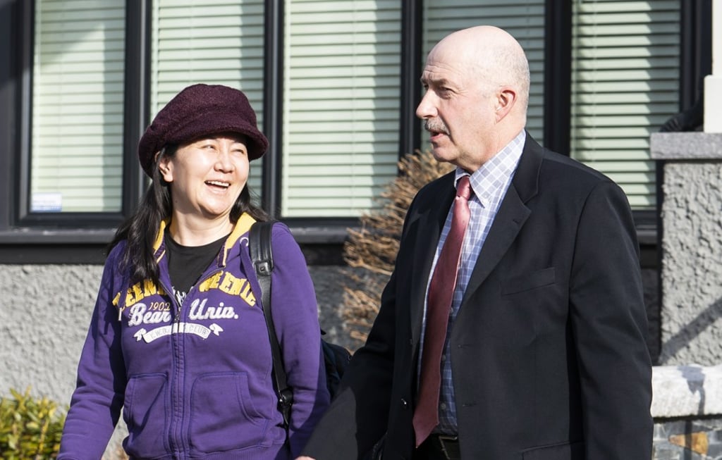 Huawei's CFO Meng Wanzhou leaves her home in Vancouver, accompanied by a guard from Lions Gate Risk Management, on March 6. Photo: EPA