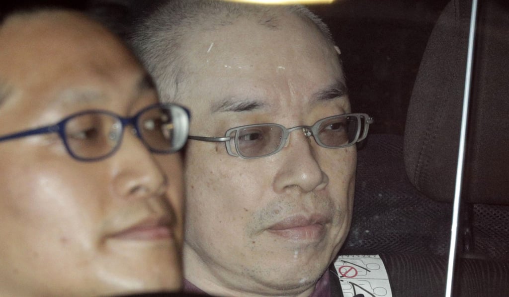 Kaoru Hasegawa, right, is driven to a police station after being arrested. Photo: Kyodo Kaoru Hasegawa, right, is driven to a police station after being arrested. Photo: Kyodo