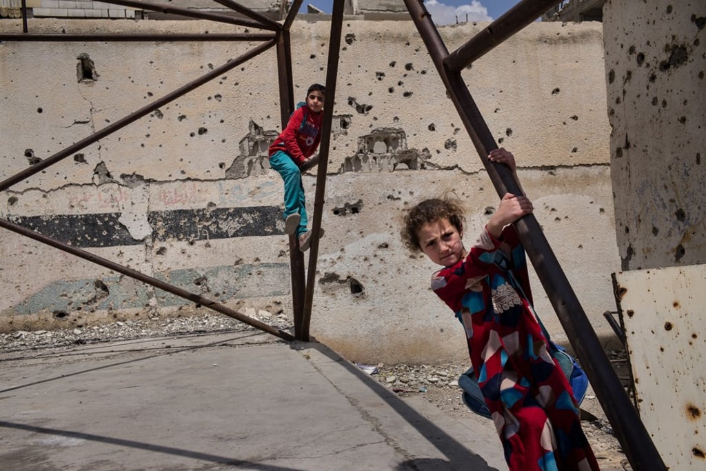 Children play in the courtyard at the heavily damaged Hawari Bu Medyan School in Raqqa, Syria, on May 10, 2018. The school is located opposite a building that was used by ISIS’s religious police, the Hisba, and was also the site of intense fighting during the offensive to retake the city from the extremist group. Photo: Nicole Tung