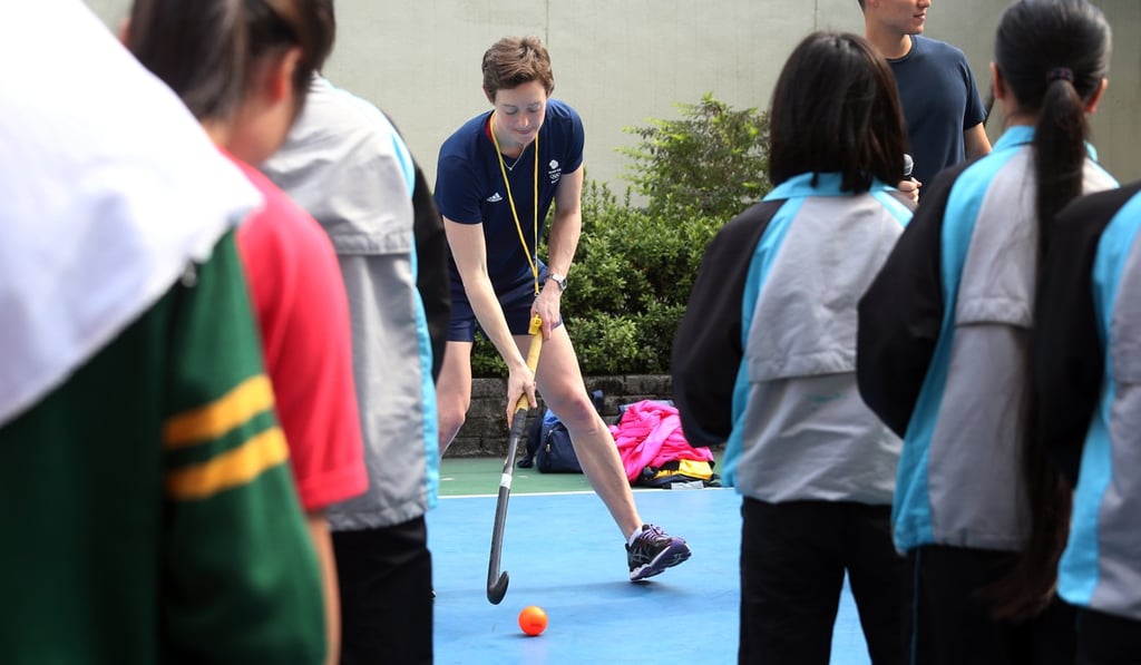 Hannah MacLeod, part of the English field hockey team that won Olympic gold in 2016, leads Hong Kong students in a hockey clinic in March 2017, where she urged them to take an interest in more than just academics. Photo: K.Y. Cheng