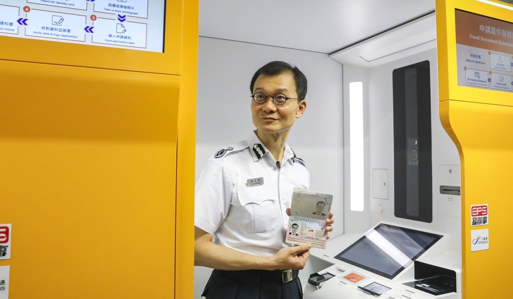 Chan Tin-chee, assistant director of immigration, tries out the new self-service booths. Photo: K.Y. Cheng