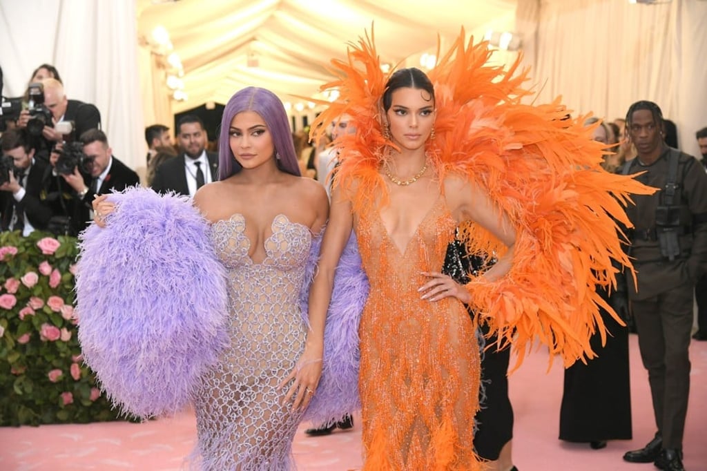Feathers do not a camp costume make. A little more effort to understand the theme was needed from the Jenner sisters. Photo: AFP