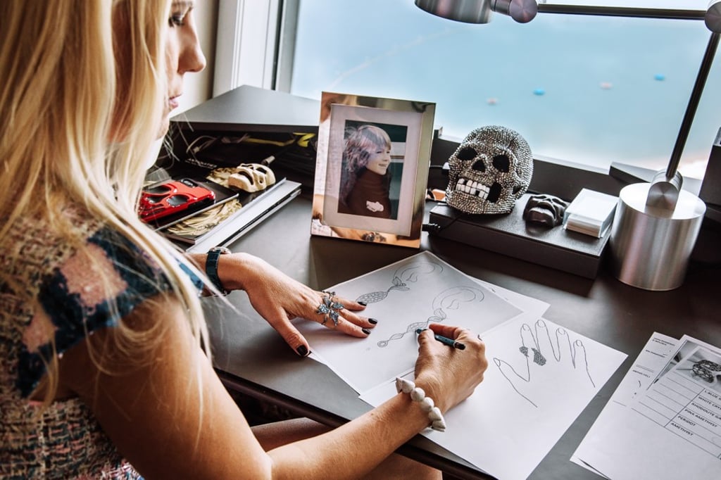 Corina Larpin sits at her desk, with a photo of her 13-year-old son, Alex, in front of her, as she works on new designs for her jewellery brand, Stéfère. Photo: Akif Hakan Celebi