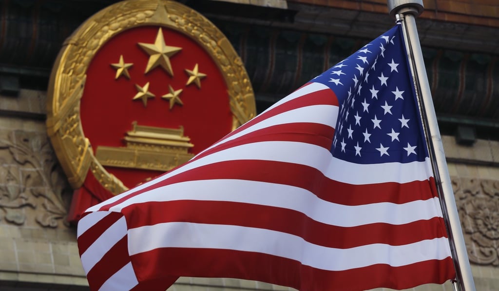 An American flag is flown next to the Chinese national emblem at the Great Hall of the People in Beijing in 2017. Photo: AP