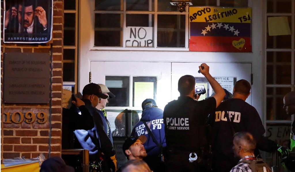 Police and Secret Service agents prepare to enter the embassy to evict and arrest the final four supporters of President Nicolas Maduro. Photo: Reuters