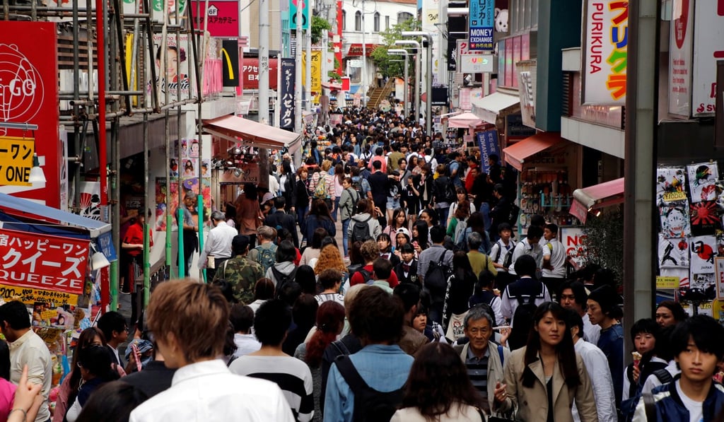 People walk on a street in a busy shopping district in Tokyo, Japan May 17, 2017. REUTERS/Toru Hanai/File Photo