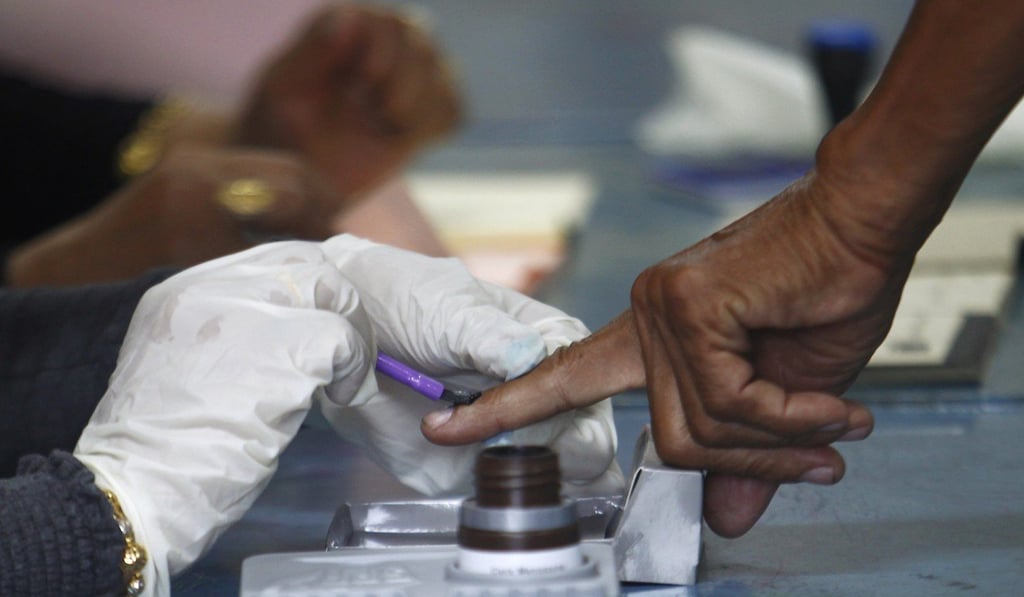 A voter has his finger painted with indelible ink before casting his ballot during the Malaysian election. Photo: Reuters
