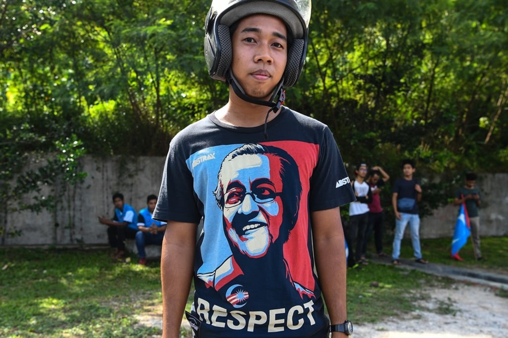 A supporter of Prime Minister Mahathir Mohamad outside the national palace in Kuala Lumpur. Photo: AFP